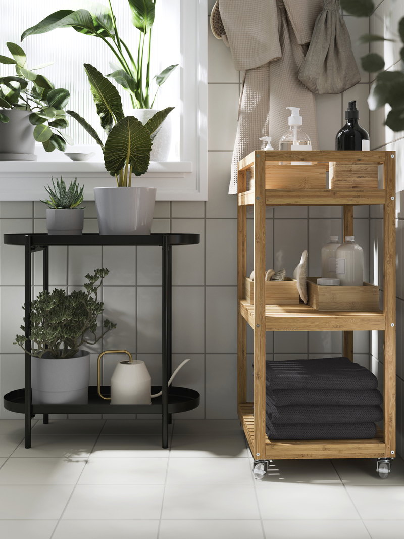 An OLIVBLAD plant stand and a RÅGRUND cart placed together in a bathroom