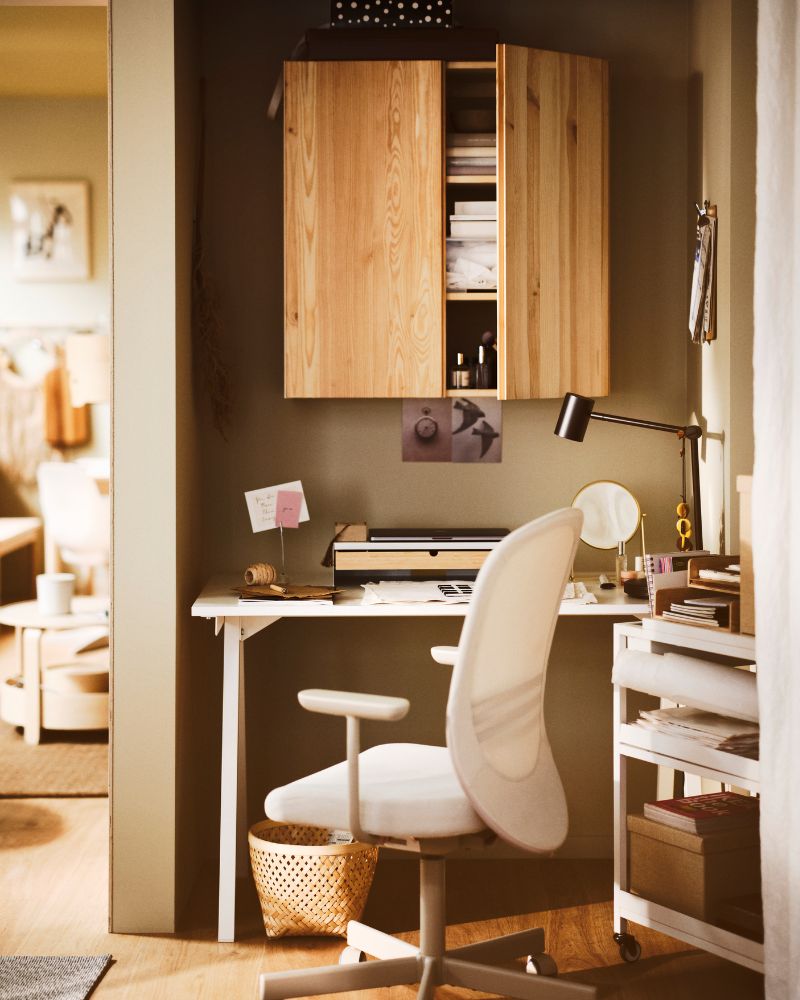  desk TROTTEN comfortable office chair with armrests and a bright work lamp.