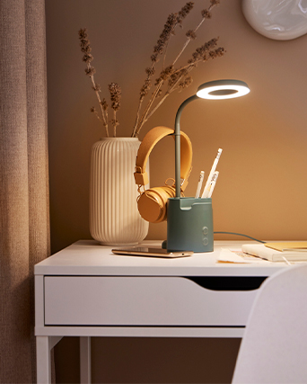 Minimalist white desk with a drawer, a modern lamp, and smart accessories, designed to create a calm and practical workspace at home.