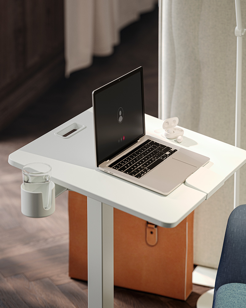 A close up of a focus corner with a white MITTZON laptop table on castors and a MITTZON acoustic screen to the side.
