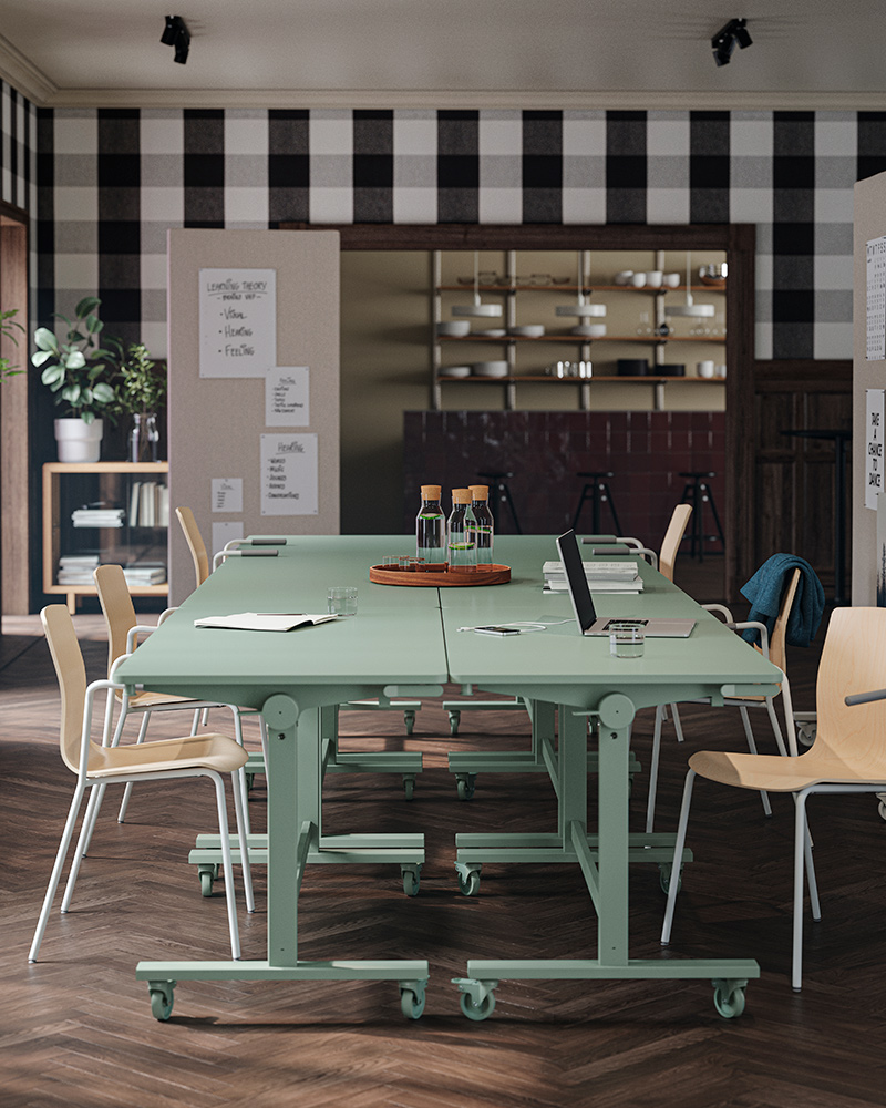 An office break room with several green MITTZON foldable tables and LÄKTARE conference chairs.