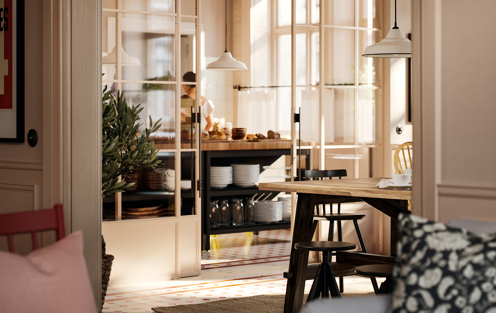 Part of an acacia SKOGSTA dining table with black legs is visible by a breakfast buffet area that is behind a glass wall.