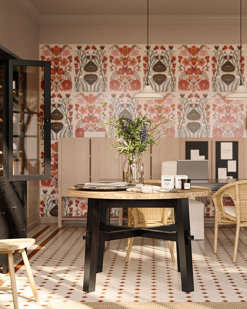 A SKOGSTA dining table with an acacia top and black legs holds a vase and other items, in a bed and breakfast’s reception.