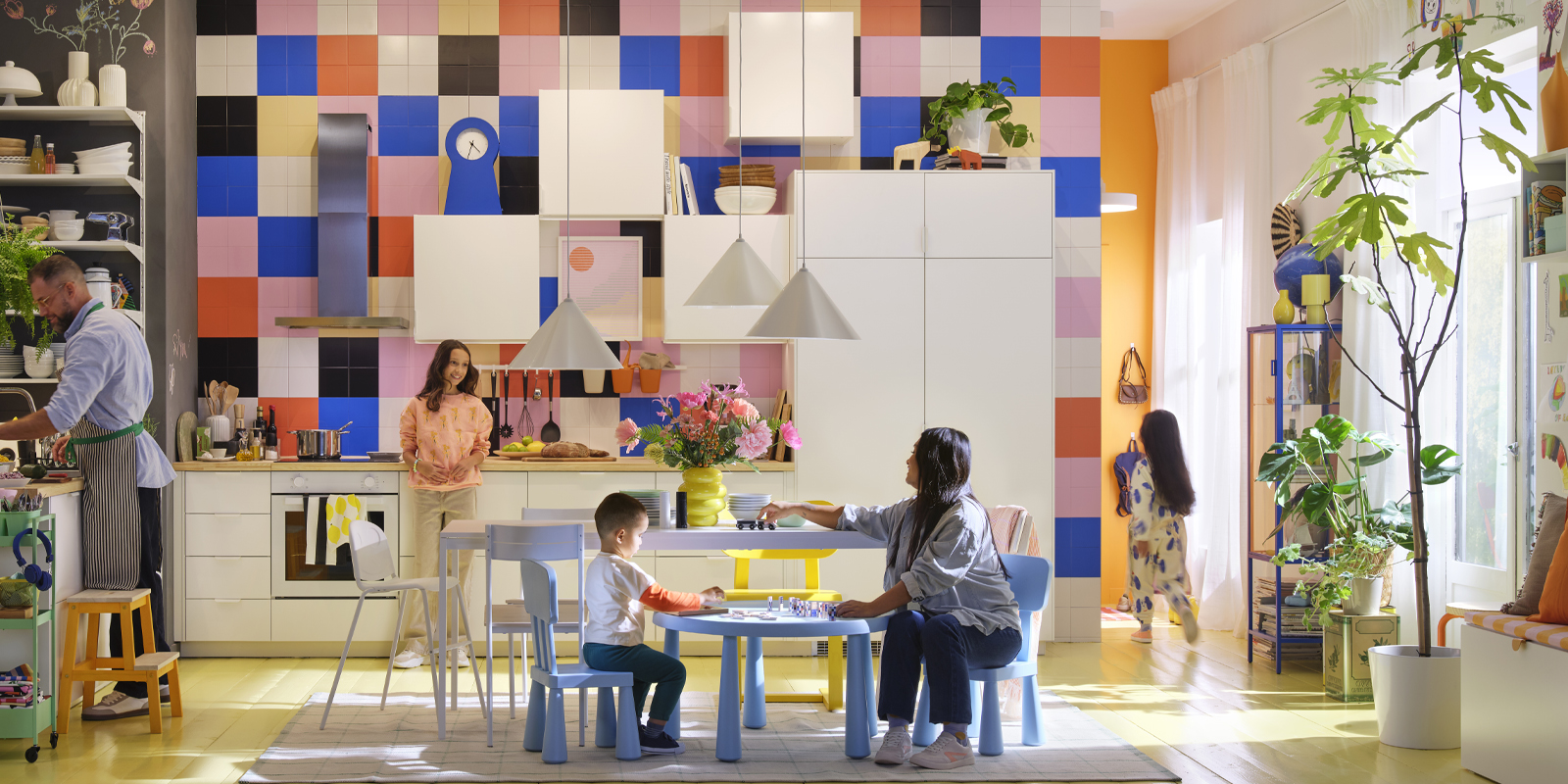 Bright and colorful family-style kitchen, with people cooking, playing, and enjoying time together in a cozy and functional space.