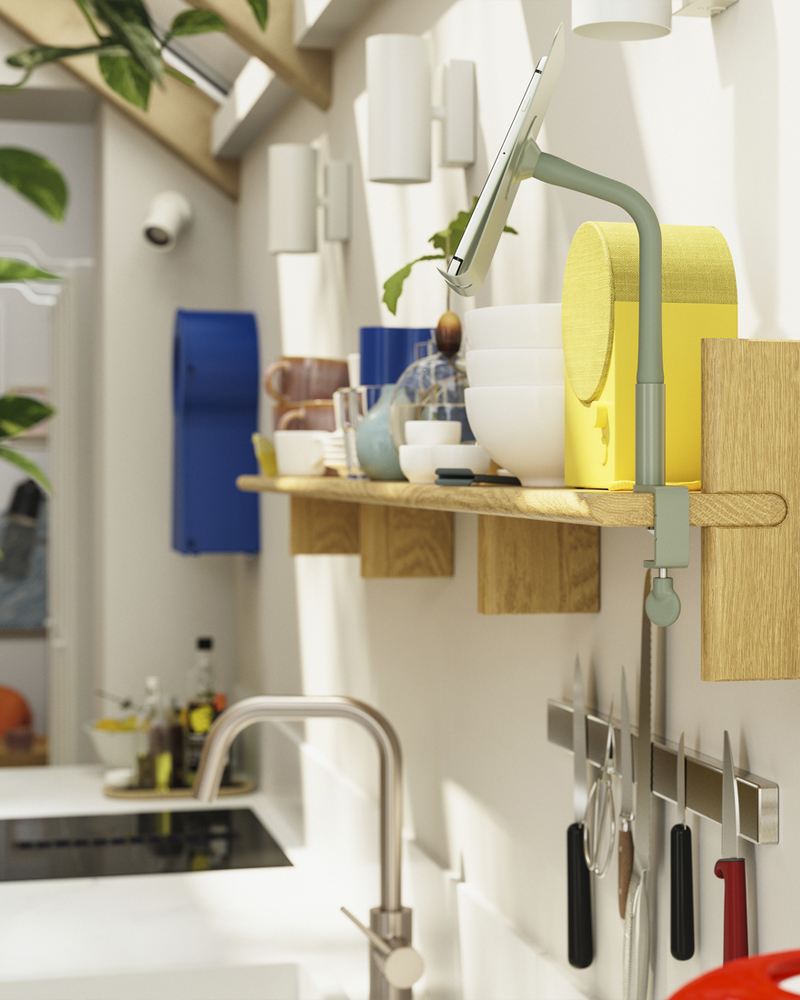A KLAVRESTRÖM wall shelf, made of solid oak, is mounted on a kitchen wall and a NATTBAD Bluetooth speaker is placed on it.