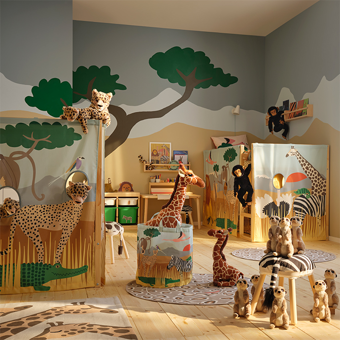 Children's room with safari theme, featuring two fabric and wood play structures, large and small stuffed animals, a leopard print rug, and storage baskets.