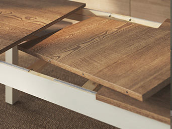 Detalle de mesa extensible con tablero de madera veteada y estructura blanca.