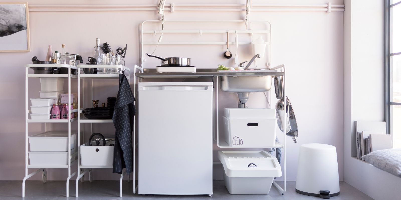 Compact kitchen with SUNNERSTA mini kitchen, LAGAN fridge, TILLREDA induction hob and SOCKERBIT storage boxes.