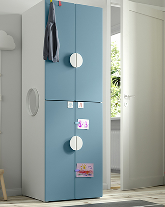A single wardrobe with blue doors placed in a child's room