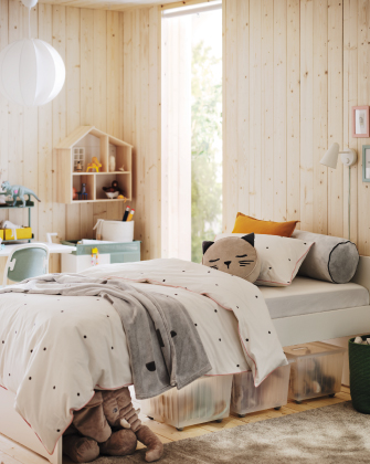 Cozy child’s bedroom with wooden walls and bed