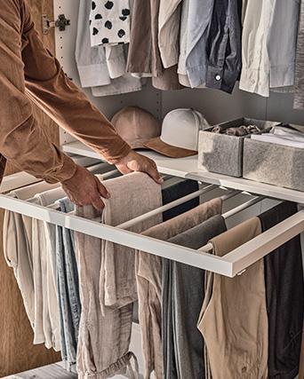 Organized closet with pull-out rack and folded clothes