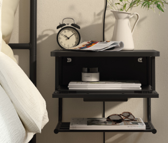 Bedside table with an alarm clock, books, and glasses.