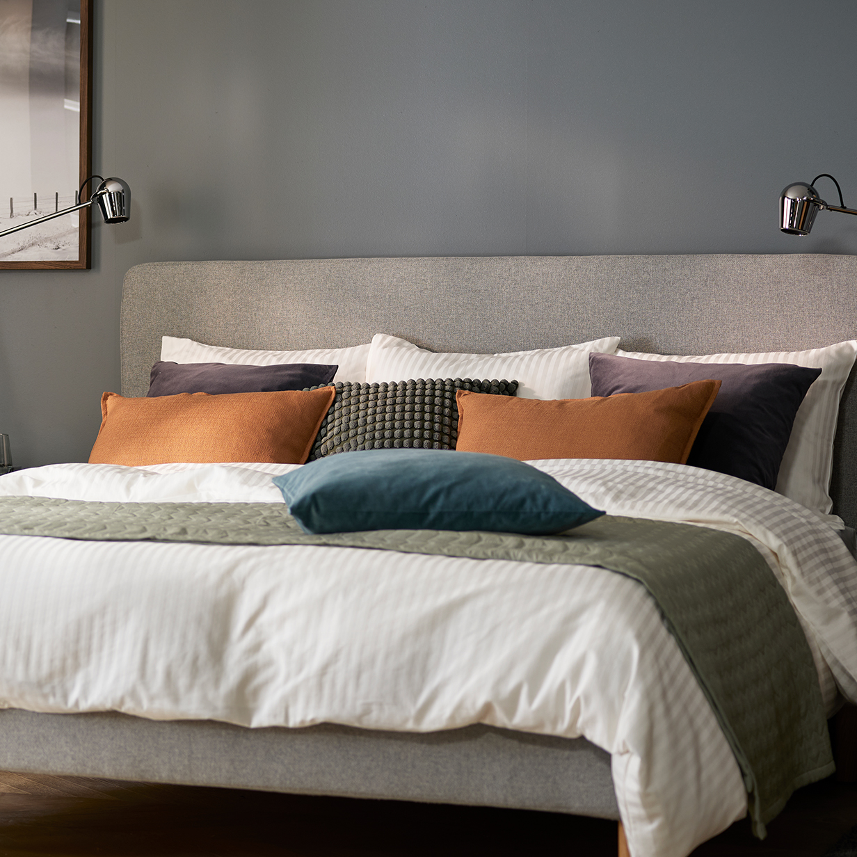 Scandinavian bedroom with light grey bed, grey bedding and clean, minimalist décor.