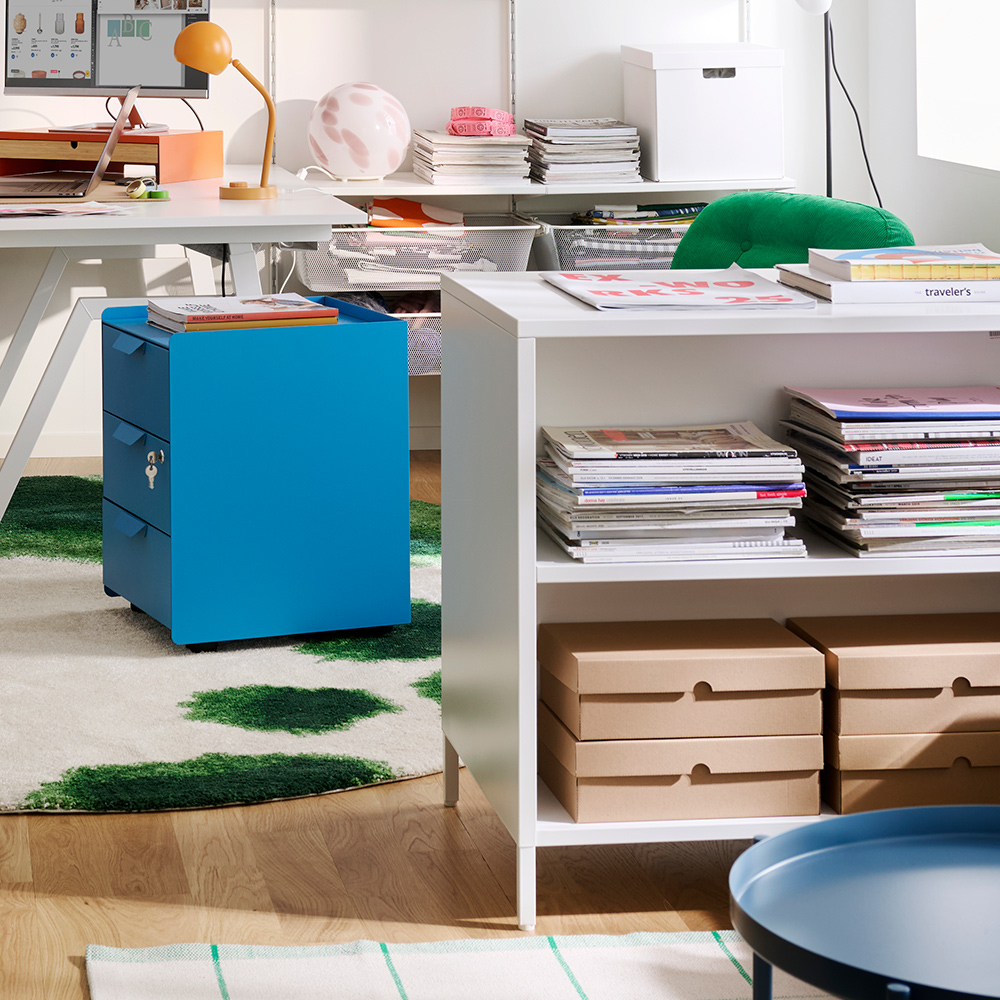 Room divided by a freestanding TROTTEN cabinet.