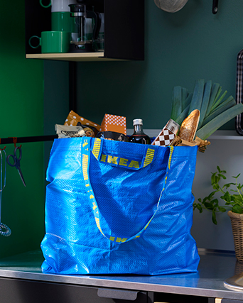 A FRAKTA bag filled with groceries on a countertop