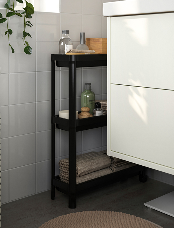 Black VESKEN trolley with wheels and three shelves for kitchen organization and storage. Ideal for storing dry foods, bottles, and kitchen essentials while maximizing space efficiently.