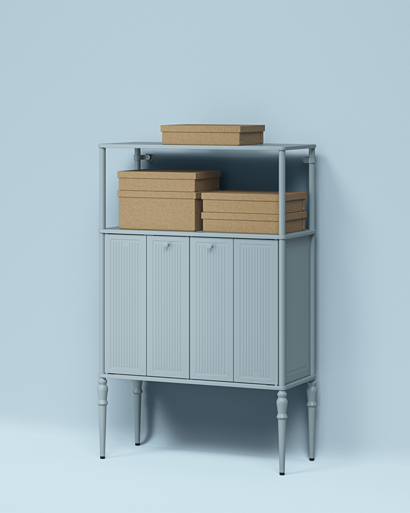 GÄRDESGÅRD storage boxes with lids stacked on the shelf of a light-grey-blue SÅGMÄSTARE cabinet against a blue background.