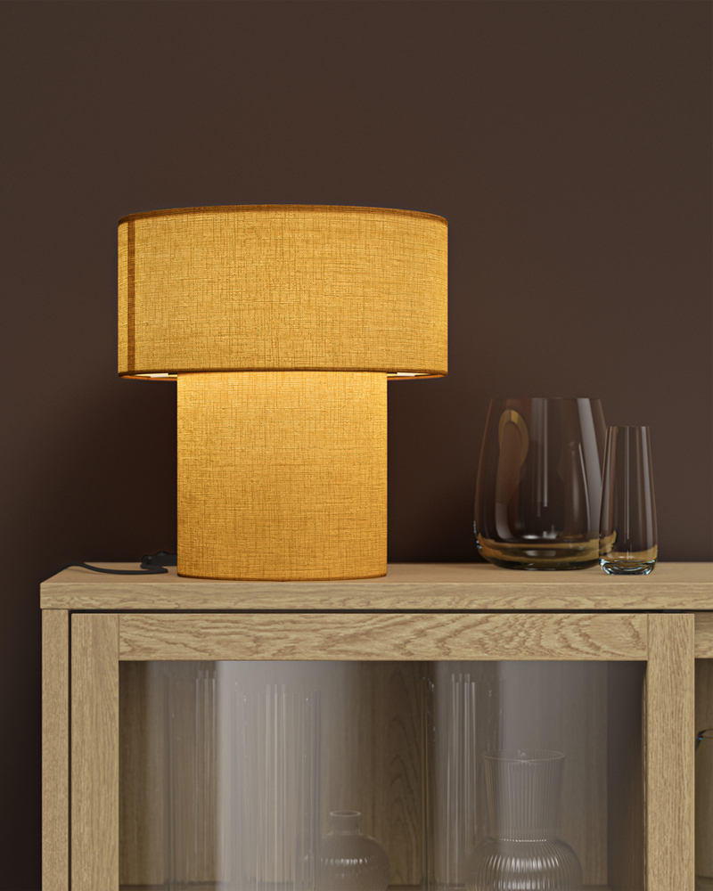 A yellow STOCKHOLM table lamp atop a TONSTAD oakveneer cabinet holding glassware, all set against a brown wall.