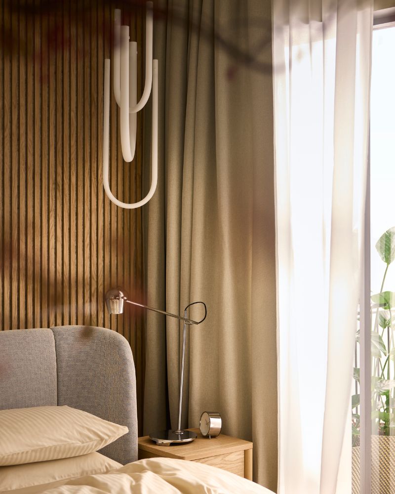 Warm bedroom with TUFJORD upholstered bed, NATTJASMIN bedding, TONSTAD nightstand, VARMBLIXT pendant lamp and DYTÅG curtains.