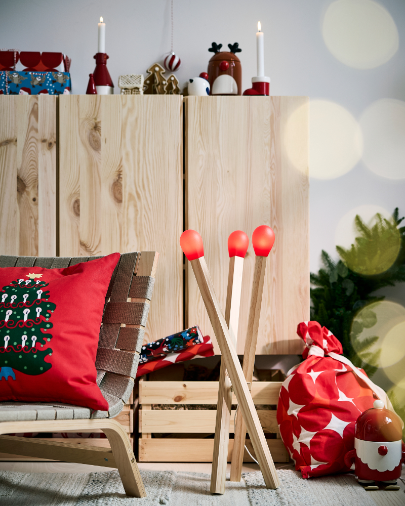 Cozy Christmas living room with wooden furniture, red decor, and festive lighting