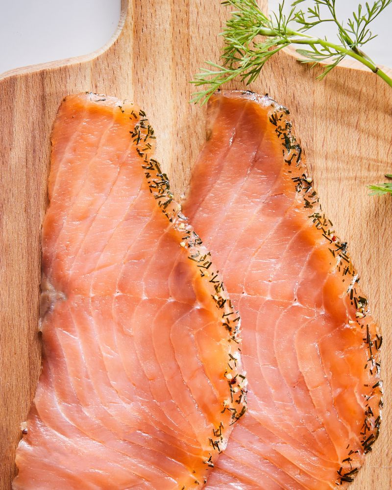 Rustic kitchen scene with SJÖRAPPORT cold-smoked cured salmon on a PROPPMÄTT chopping board.