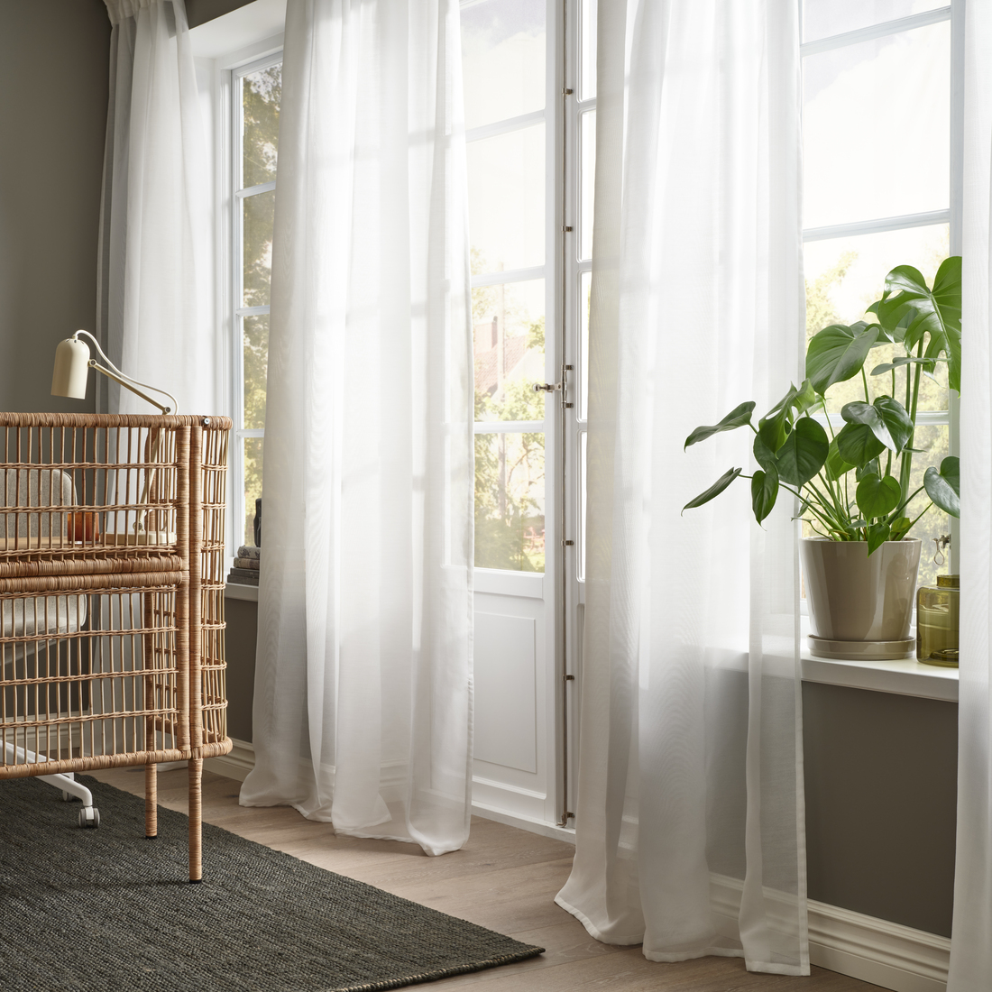 Light curtains by a window with plants.