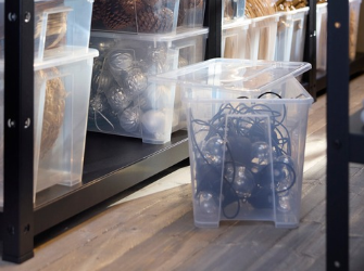Clear plastic storage bins on shelving.