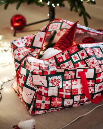 Christmas patterned bag beside a Christmas tree.