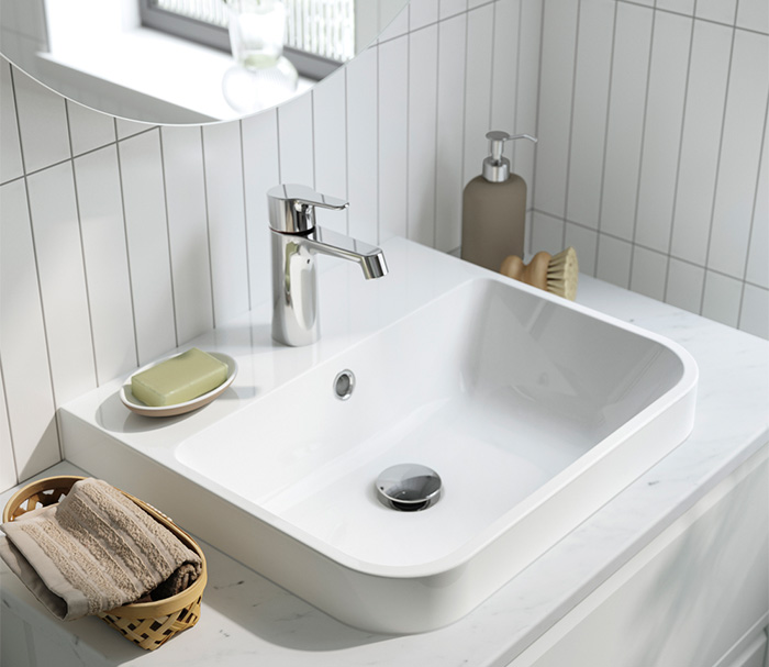 Modern white sink with chrome faucet.