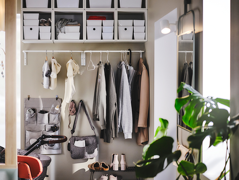 A small, contemporary hallway filled with family storage
